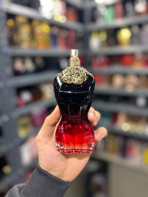 a person holding a bottle of perfume in a store
