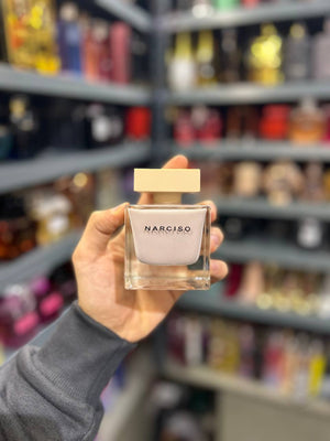 a person holding a bottle of narcino in a store