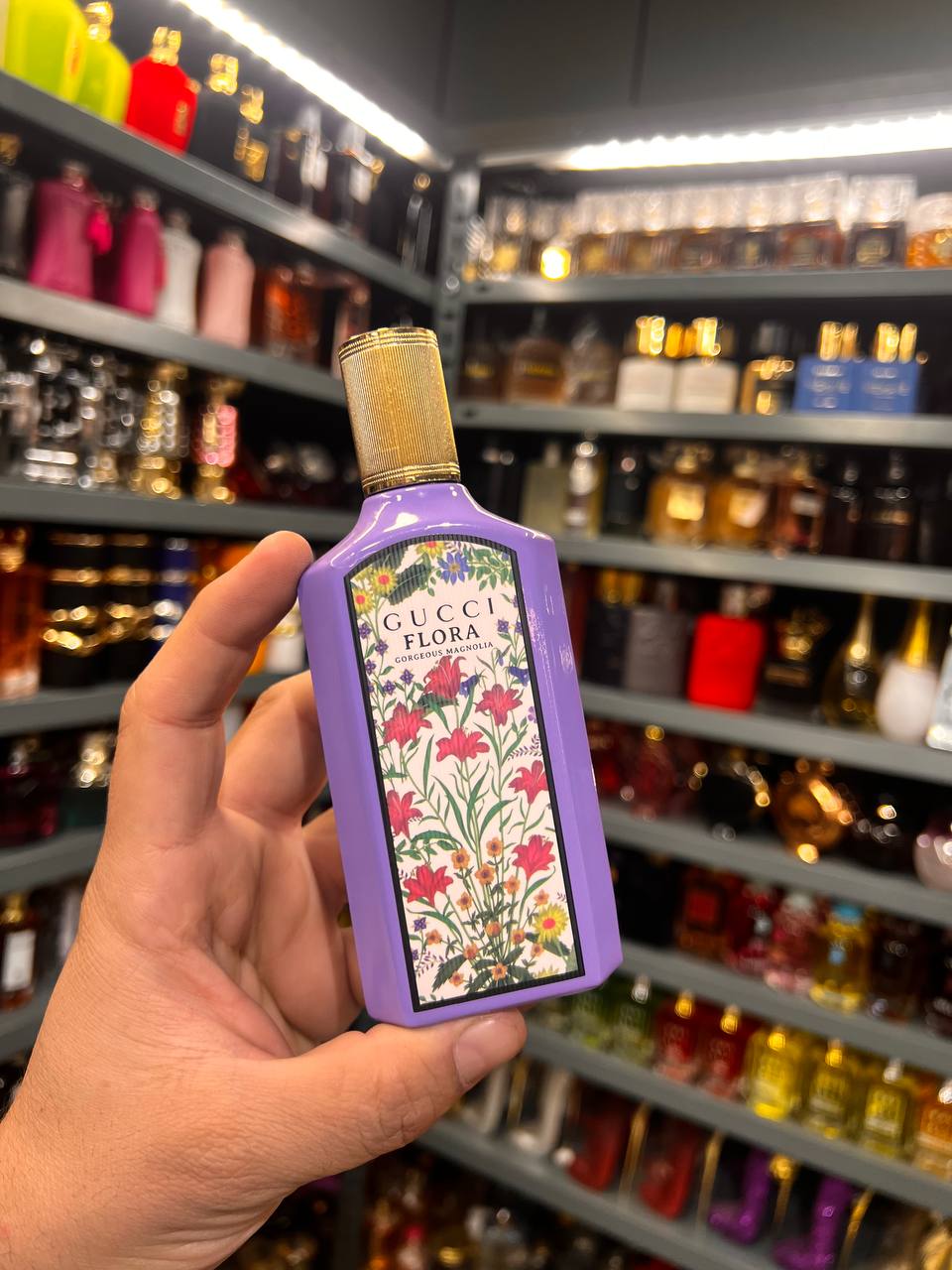 a person holding a purple flask in a store
