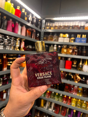 a person holding a bottle of perfume in a store
