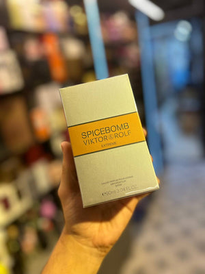 a person holding up a box of spice