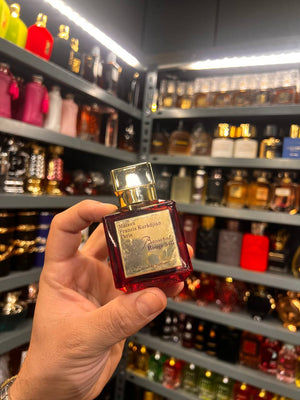 a person holding a bottle of perfume in a store