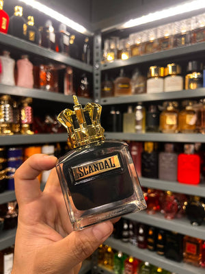 a person holding a bottle of perfume in a store