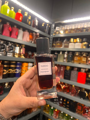 a person holding a bottle of cologne in a store