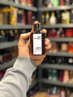 a person holding a bottle of perfume in a store