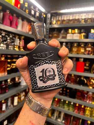 a person holding a bottle of perfume in a store