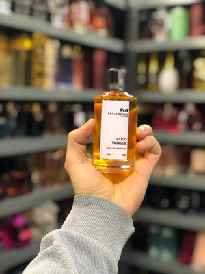 a person holding a bottle of alcohol in a store