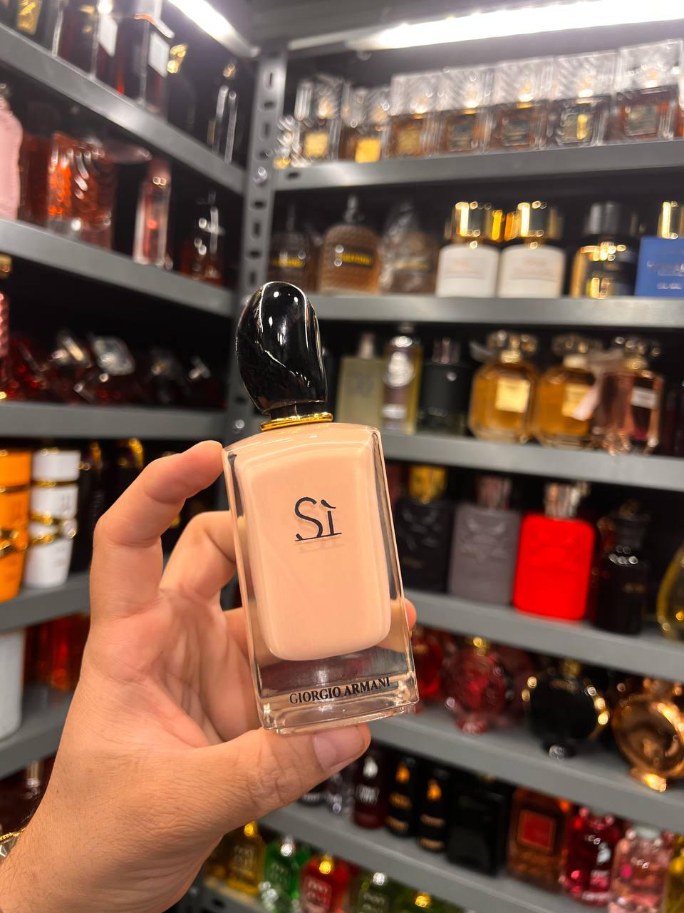 a person holding a bottle of liquid in a store