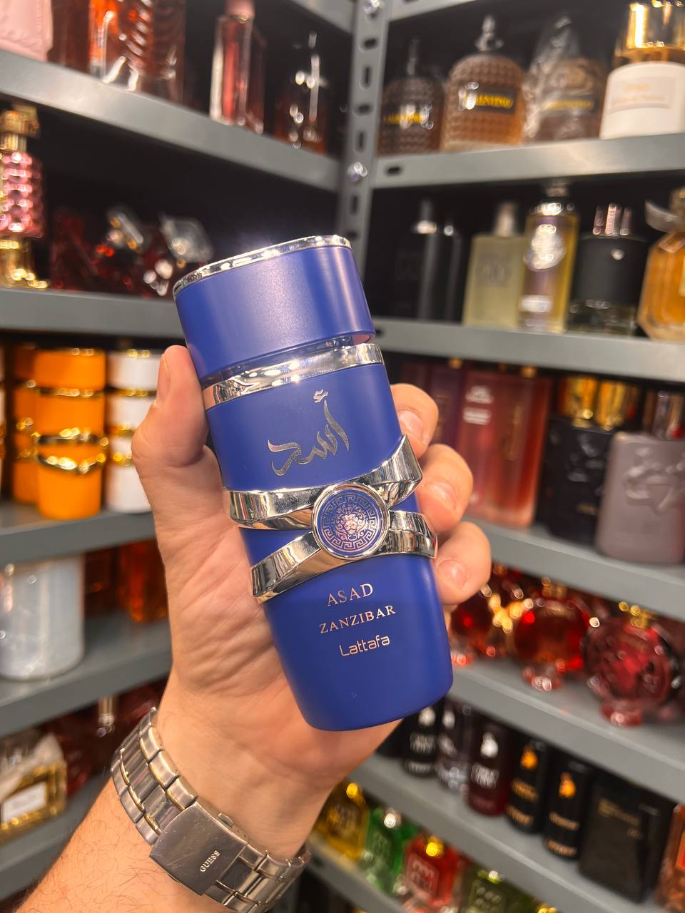 a person holding a blue flask in a store
