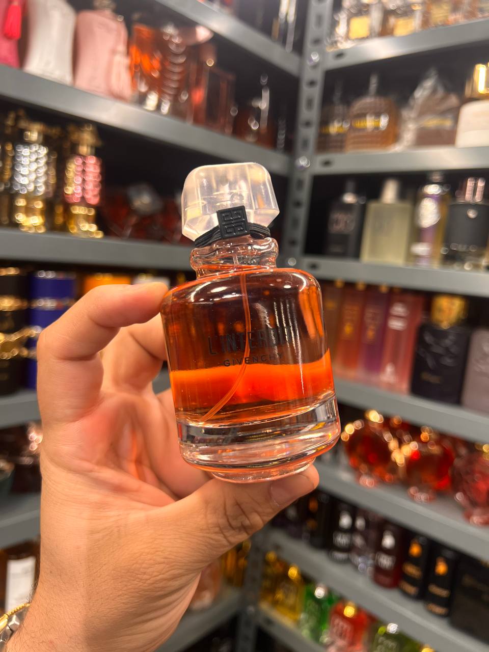 a person holding a bottle of liquor in a store