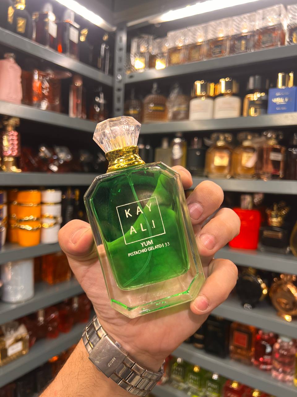 a person holding a green bottle in a store