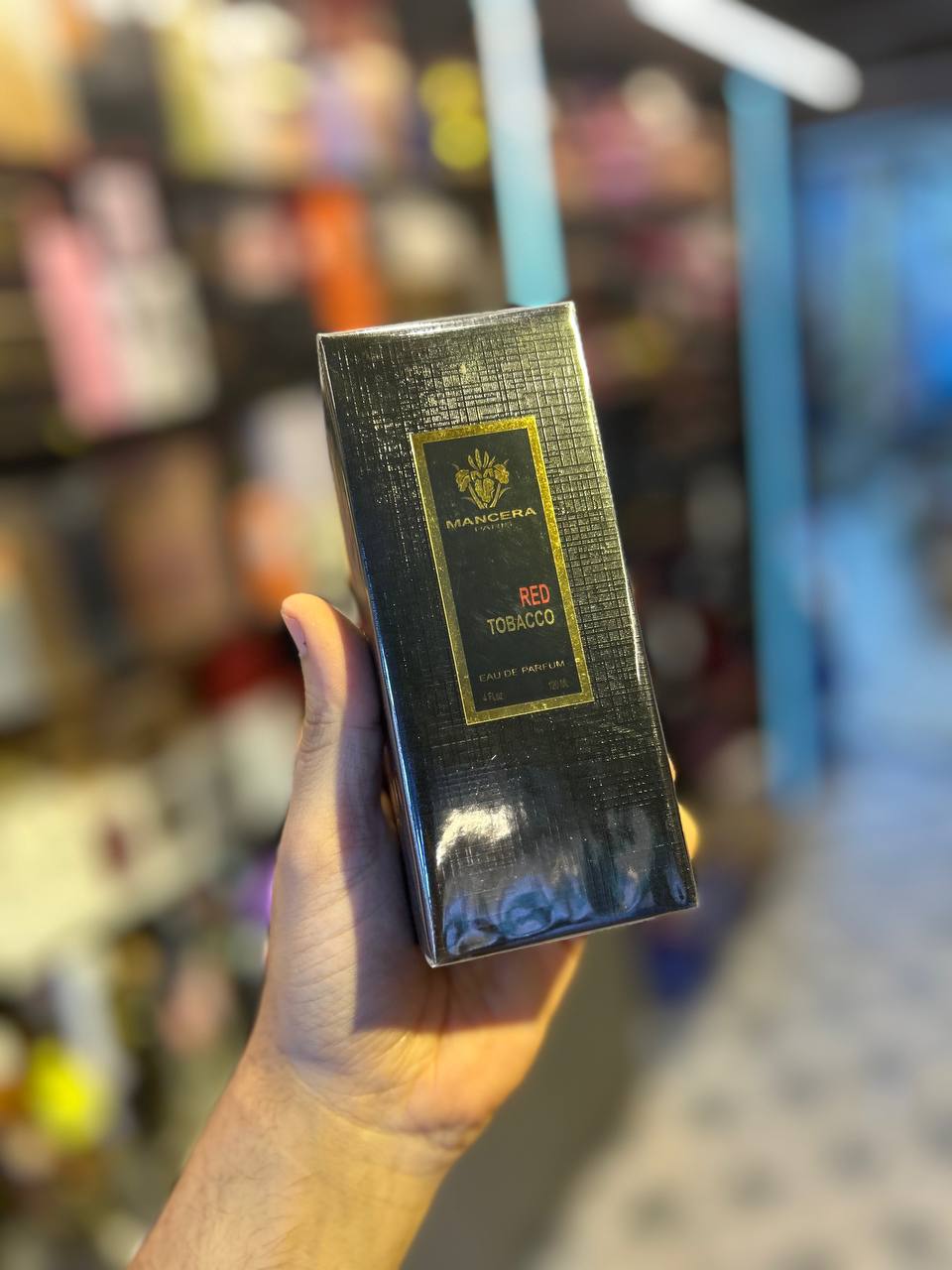 a person holding a box of chocolate in their hand
