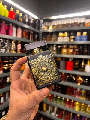 a person holding a box of perfume in a store