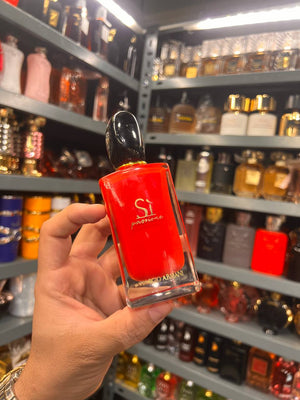 a person holding a red nail polish in a store
